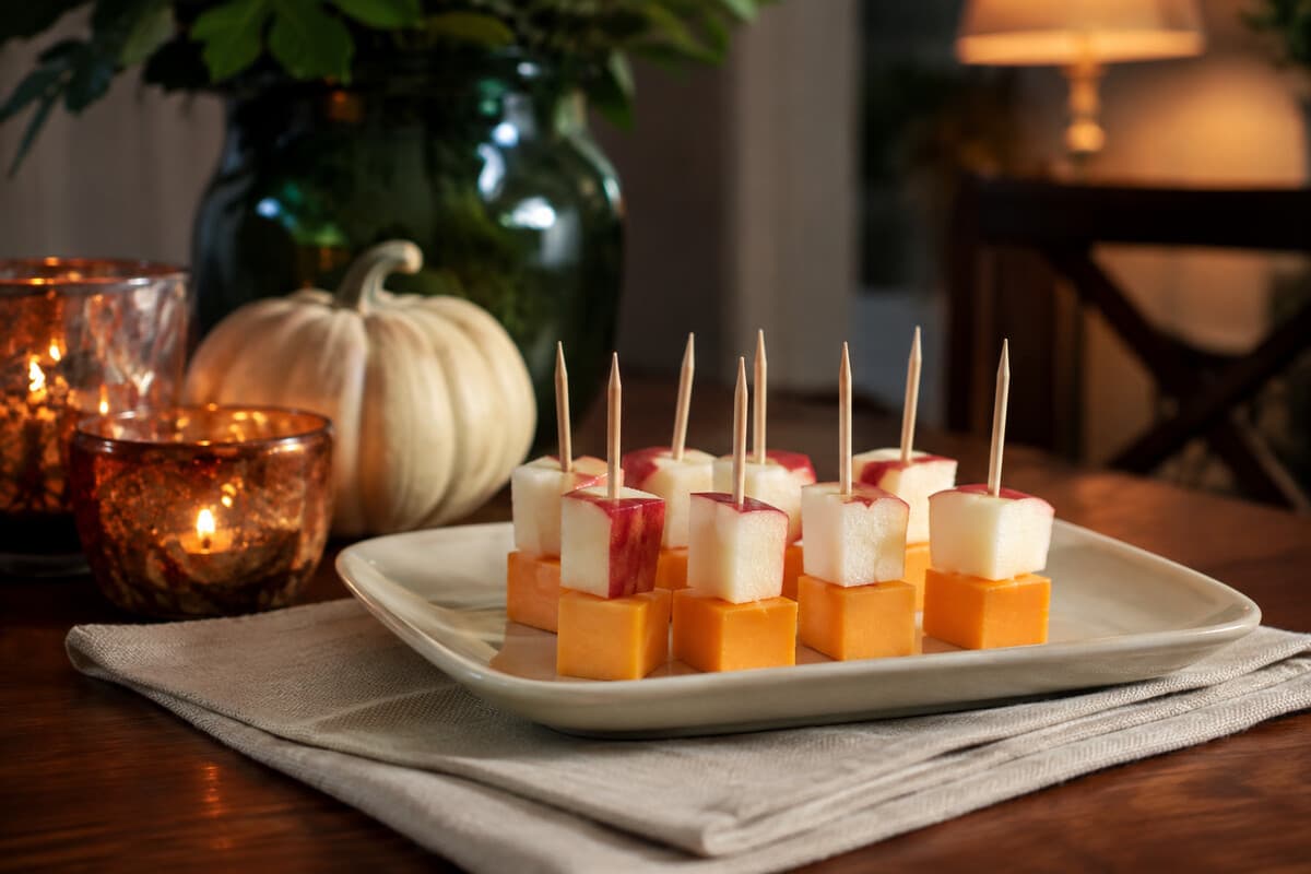 Short skewers of sharp cheddar and crisp apple on a party platter