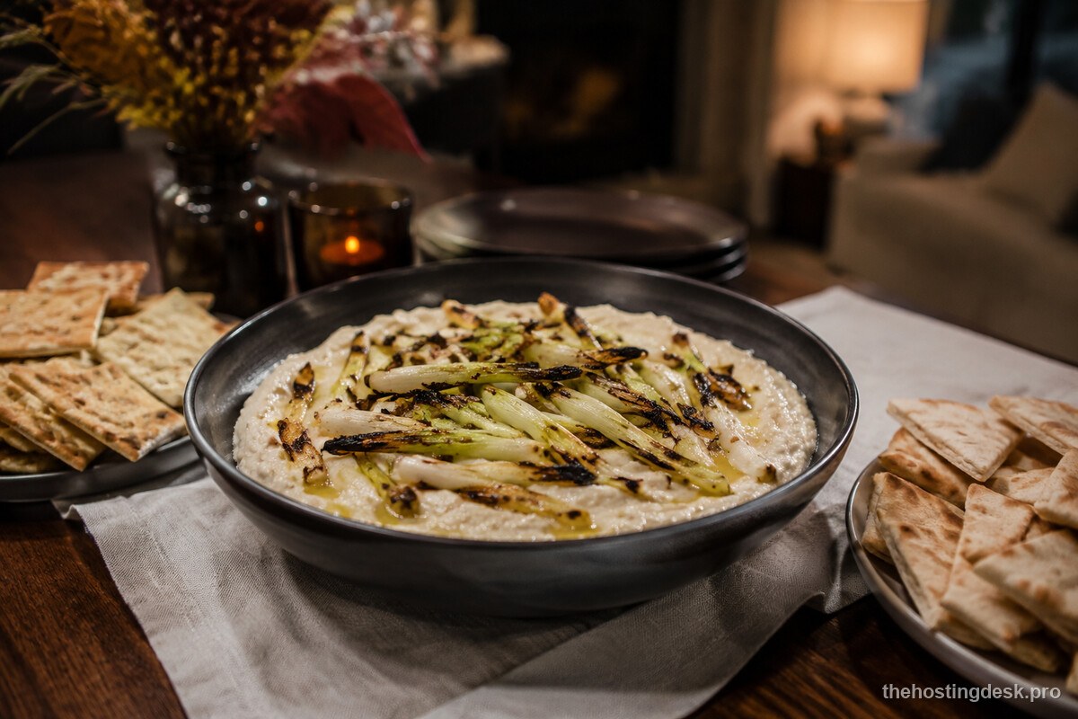Smoky white bean dip with charred scallions, crackers, and pita